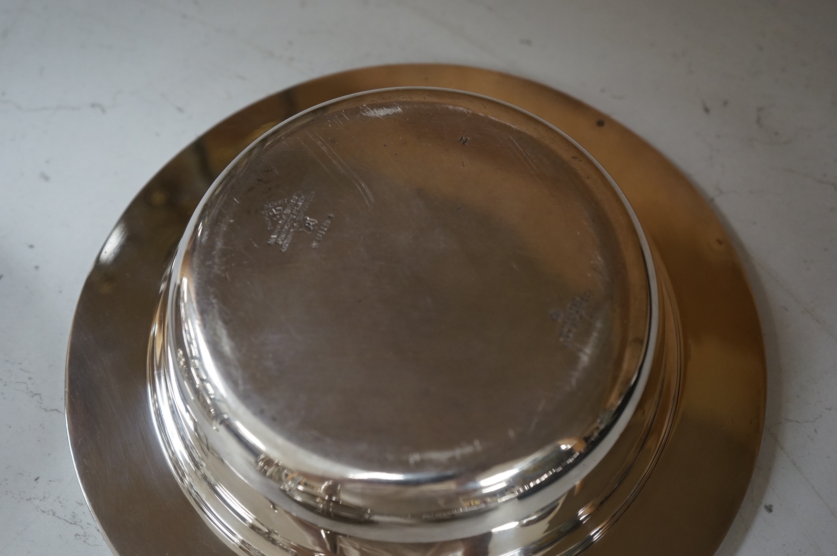 A Mappin plated muffin dish and six other plated items including three Old Sheffield plate butter shells, a wine funnel, Elkington & Co cream jug and cased set of tea knives.